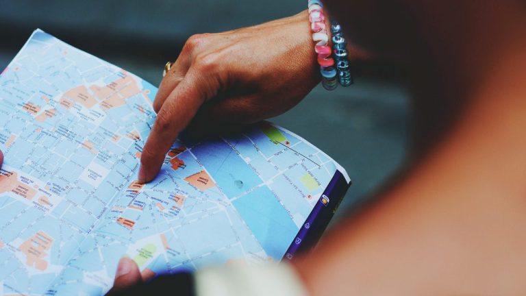 A hand searching on the map