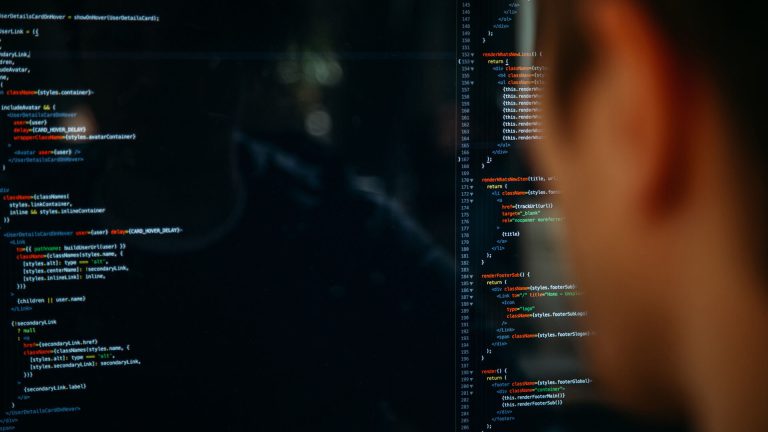 over the shoulder view of someone looking at a computer screen with HTML